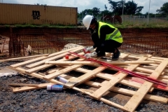 Awka Site - A STEM female student spraying the Anchor Bolts for the Workshop and Training Centre, for non-destructive test